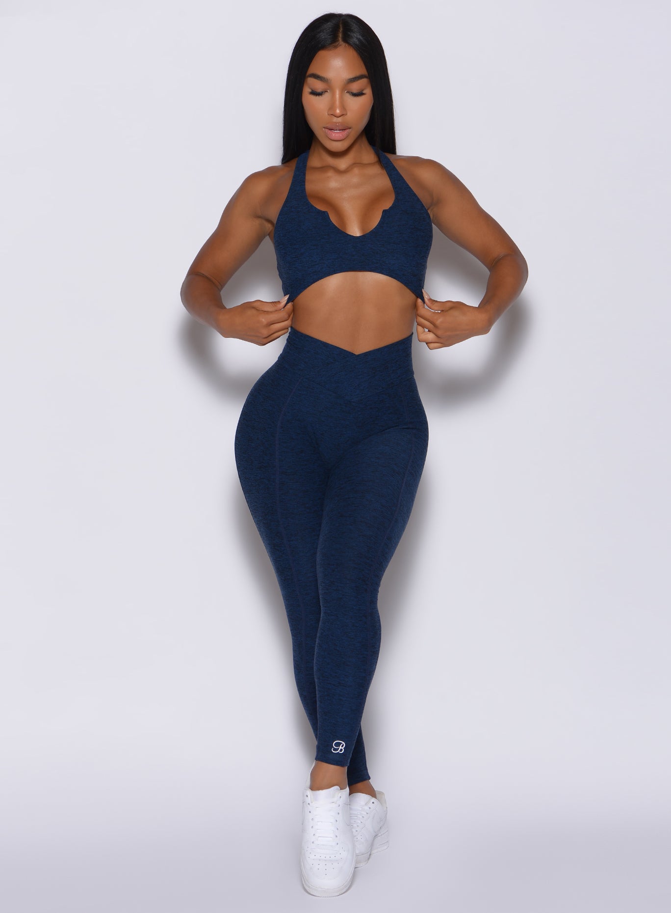 Front  profile picture of a model in our Brazilian Contour Leggings in sapphire blue color and a matching bra