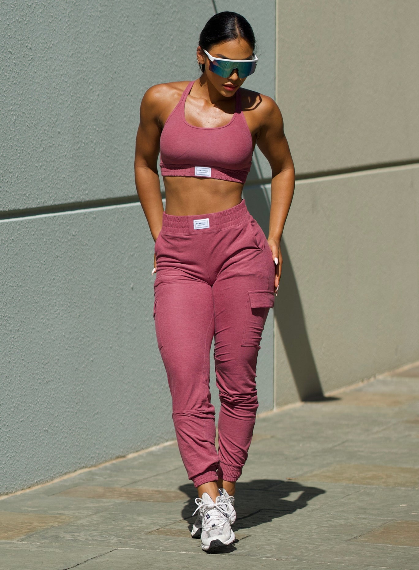 Front profile shot of our model in outdoors wearing the Cloud Lounge Bra in purple rose color with the matching joggers and sunglasses