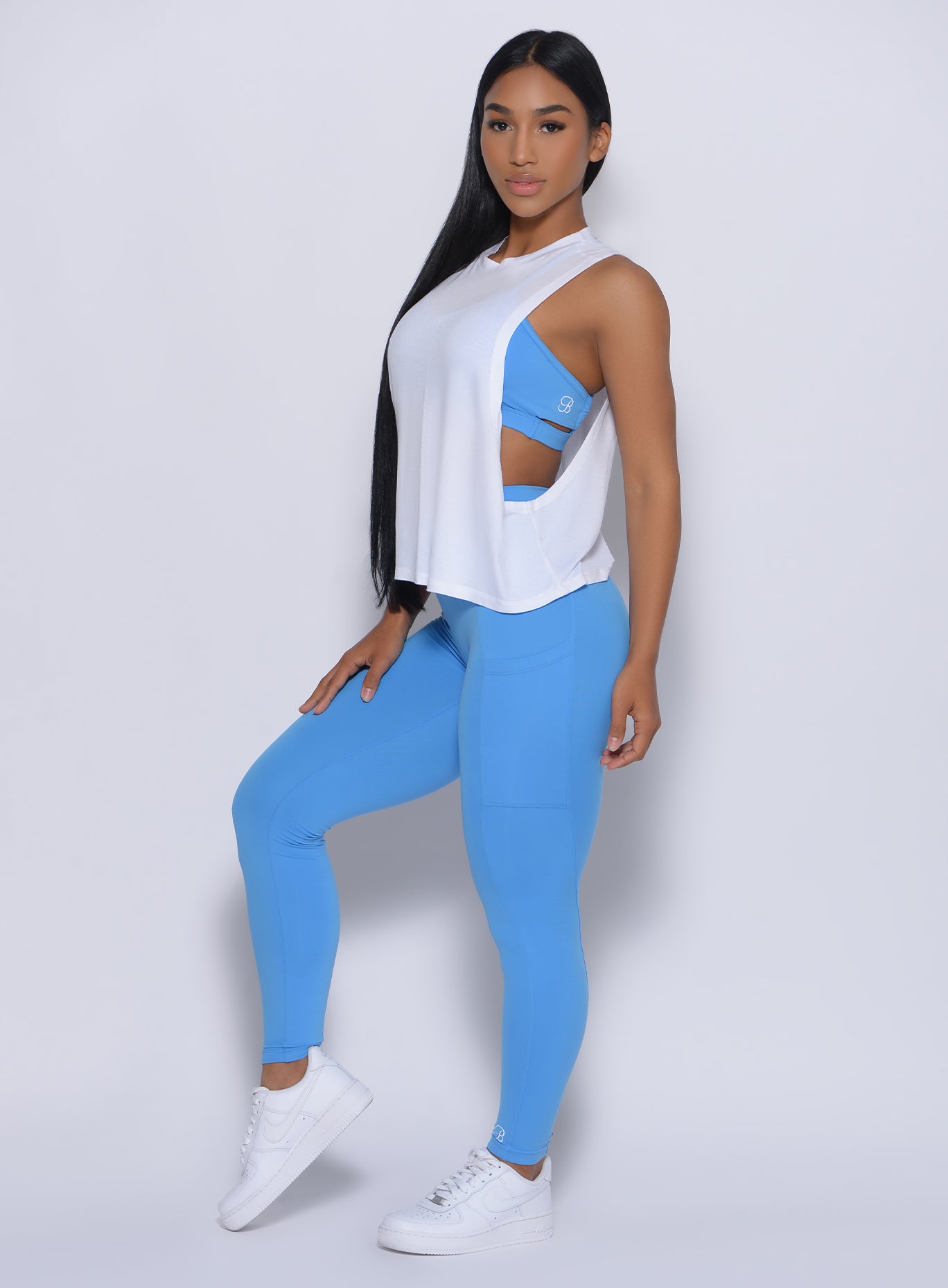 Left side profile view of the model in our curves leggings in blazing blue color