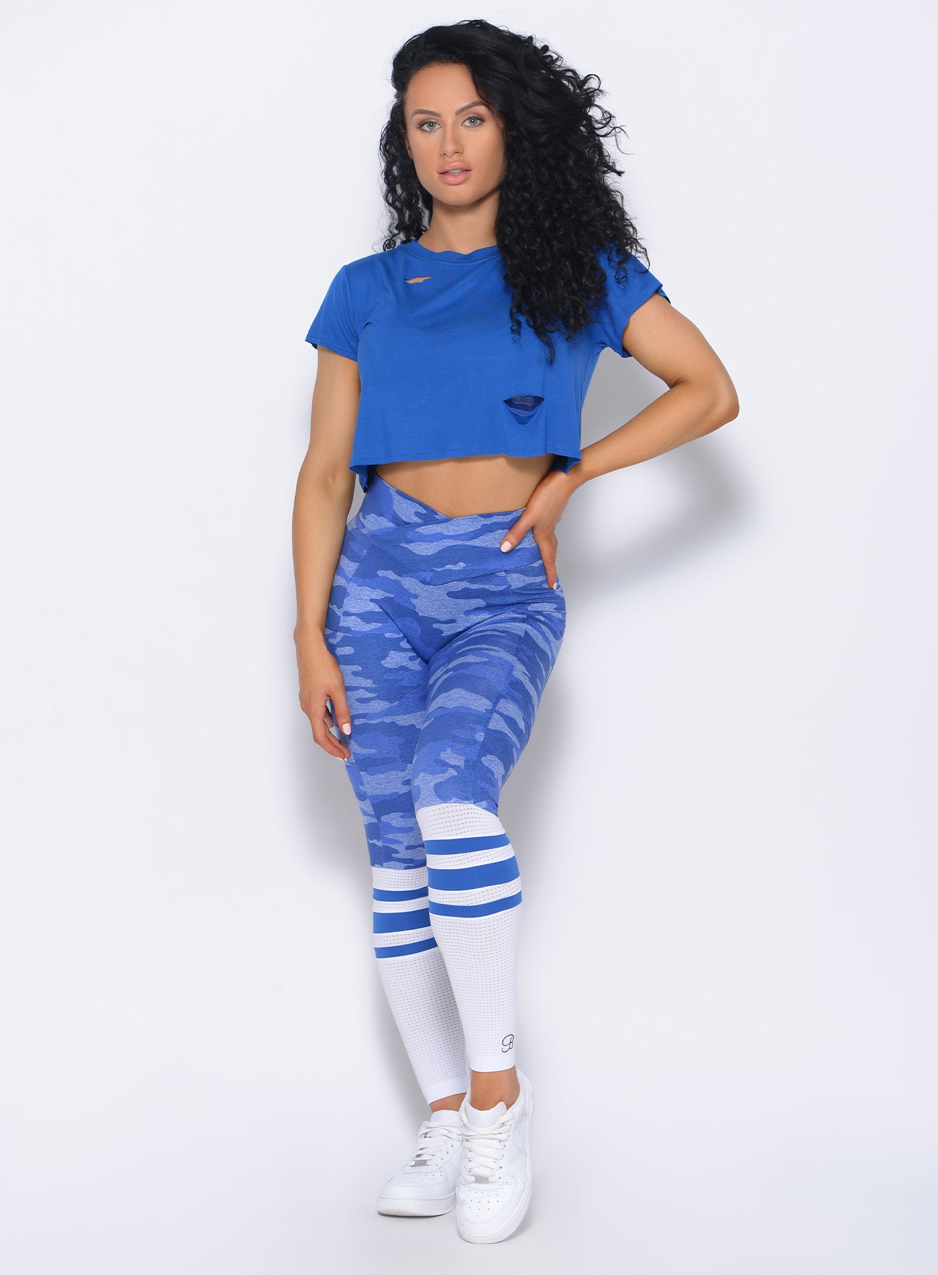 Front profile view of the model in our contour sock leggings in blue camo and a matching top